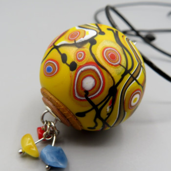 Yellow ball. Hollow bead penadnt with natural stones